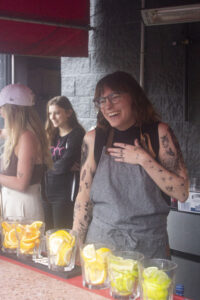 Amanda Widzinski from Mower behind the bar covered in (fake) tattoos